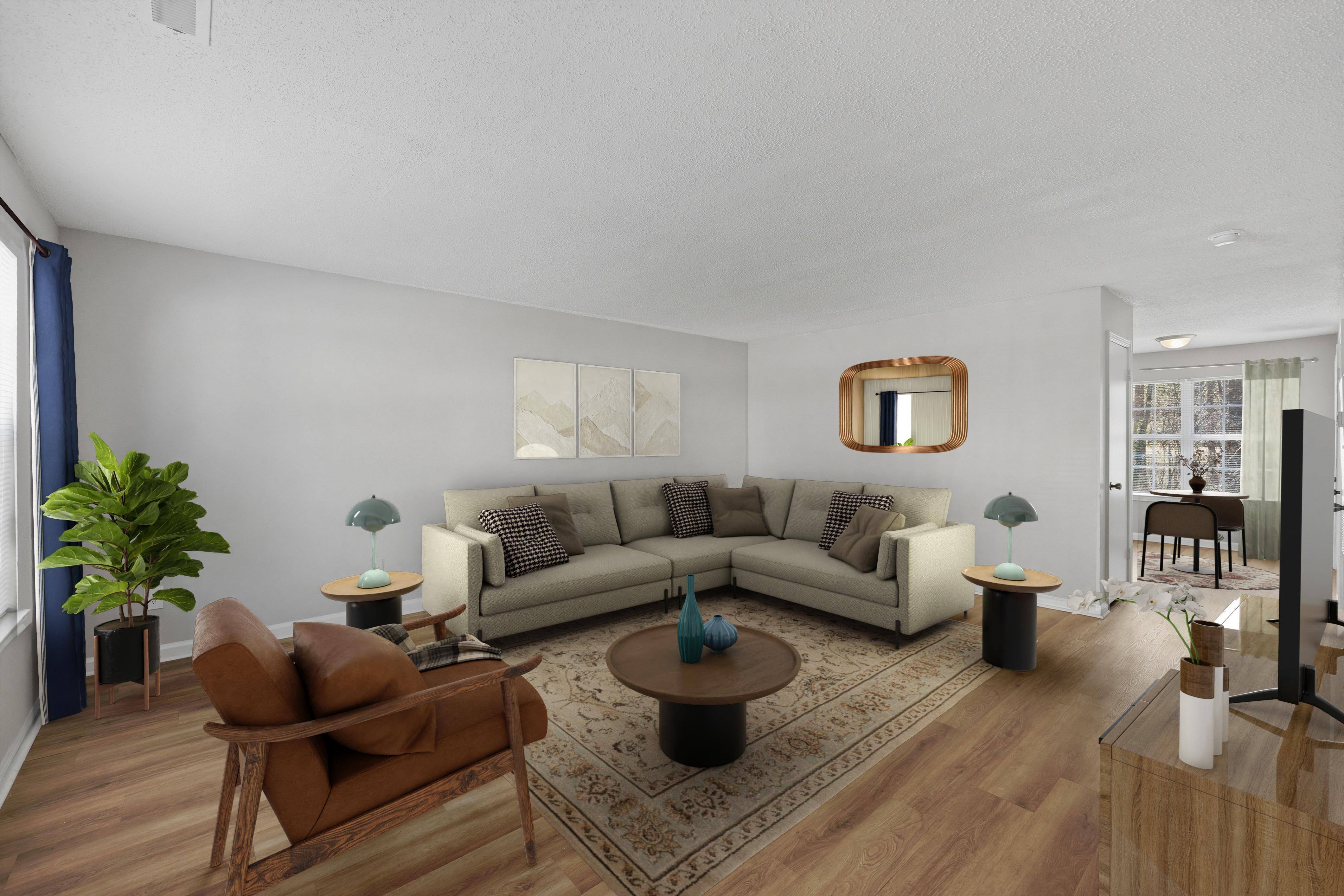 A living room with a brown leather chair and a grey sofa.